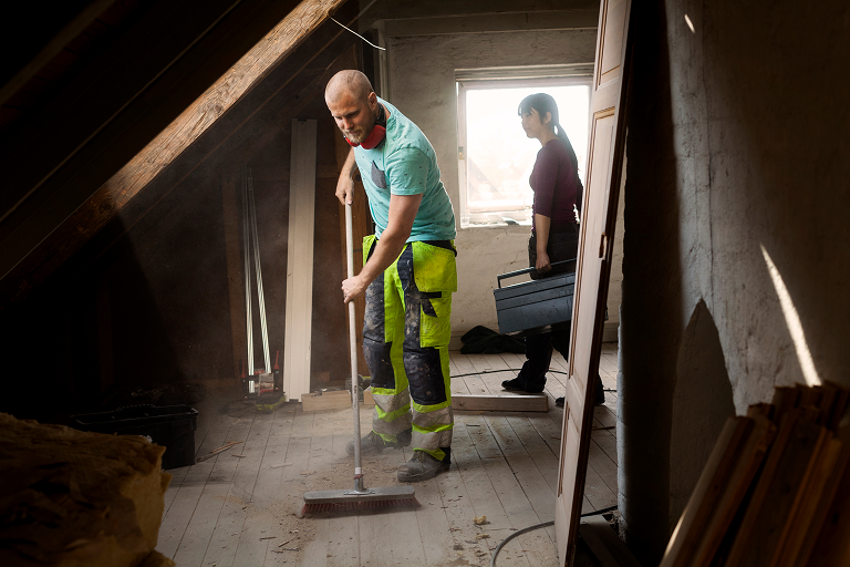 technician cleaning smoke damage in fire damaged home
